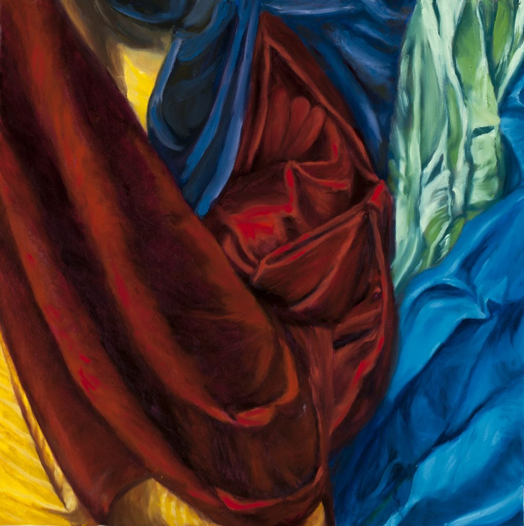 multiple color and textures of fabric draped on the wall