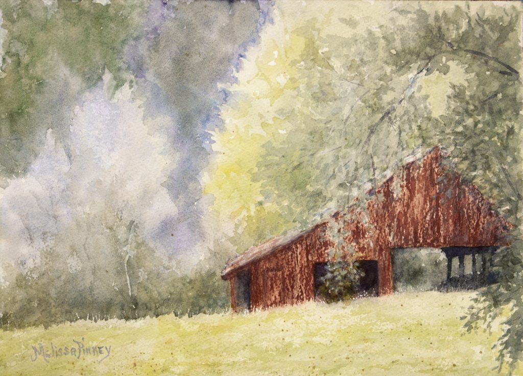 old red barn in a field surrounded by  trees
