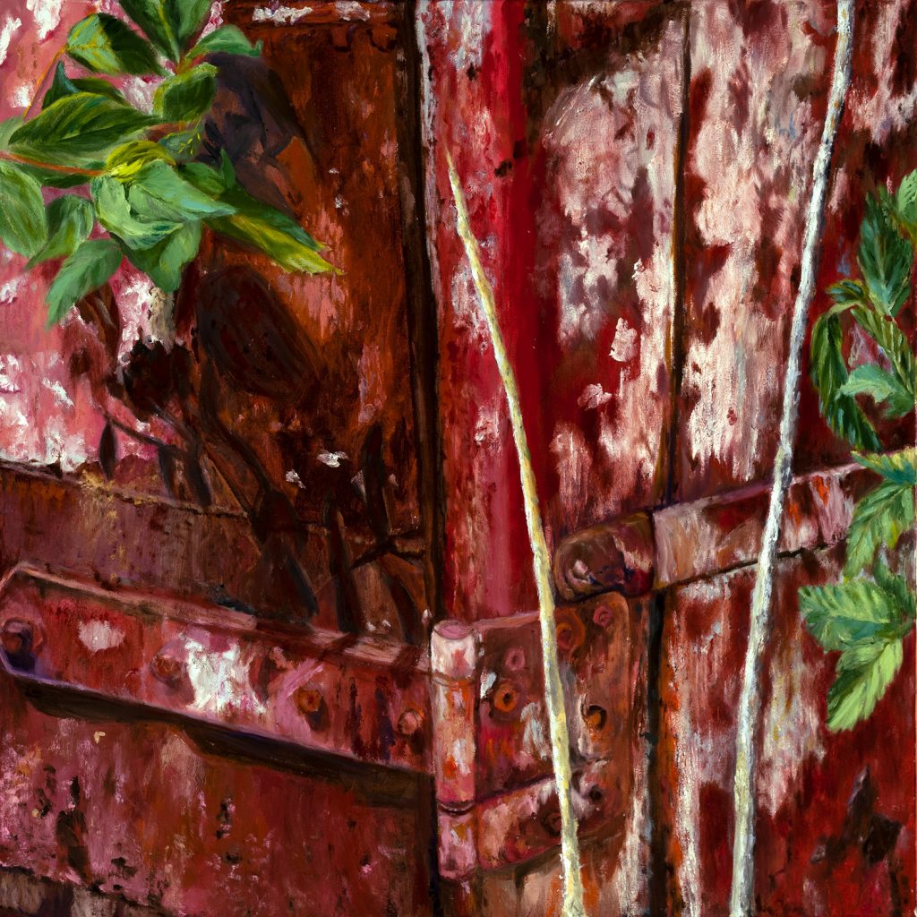 back view of a rusted red trailer with foliage growing on it - the end of the road for the trailer