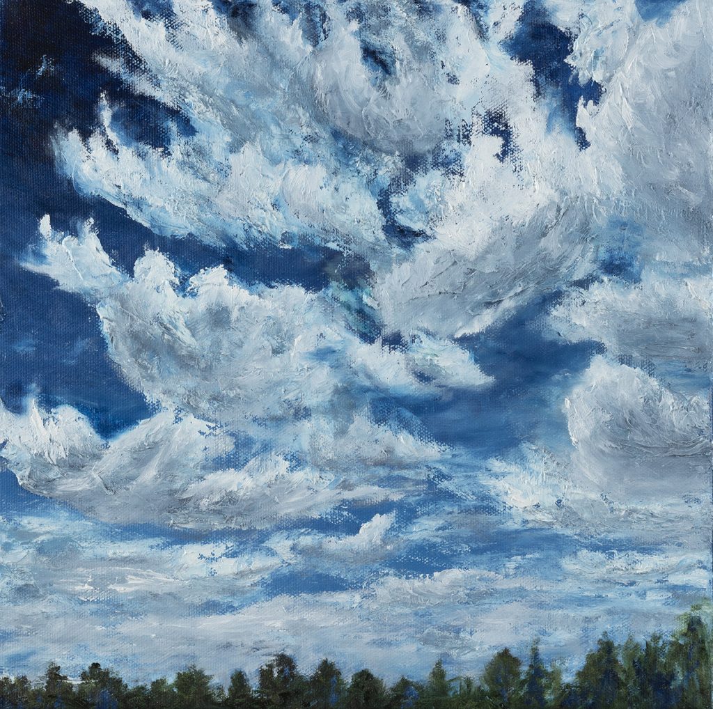 White fluffy clouds fill the blue sky